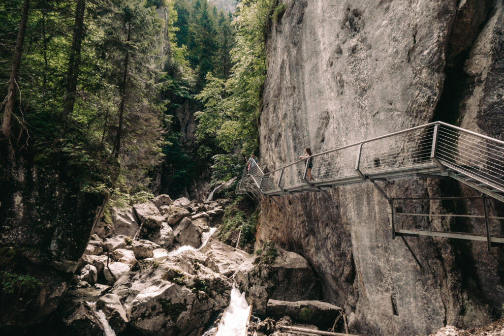 river gorge with cliffside walking path and woman looking