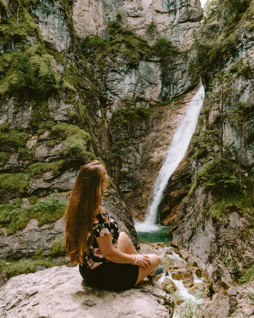 waterfall in bavaria with woman stone cliffs