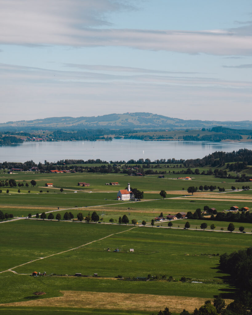 small church fields and lake in bavaria