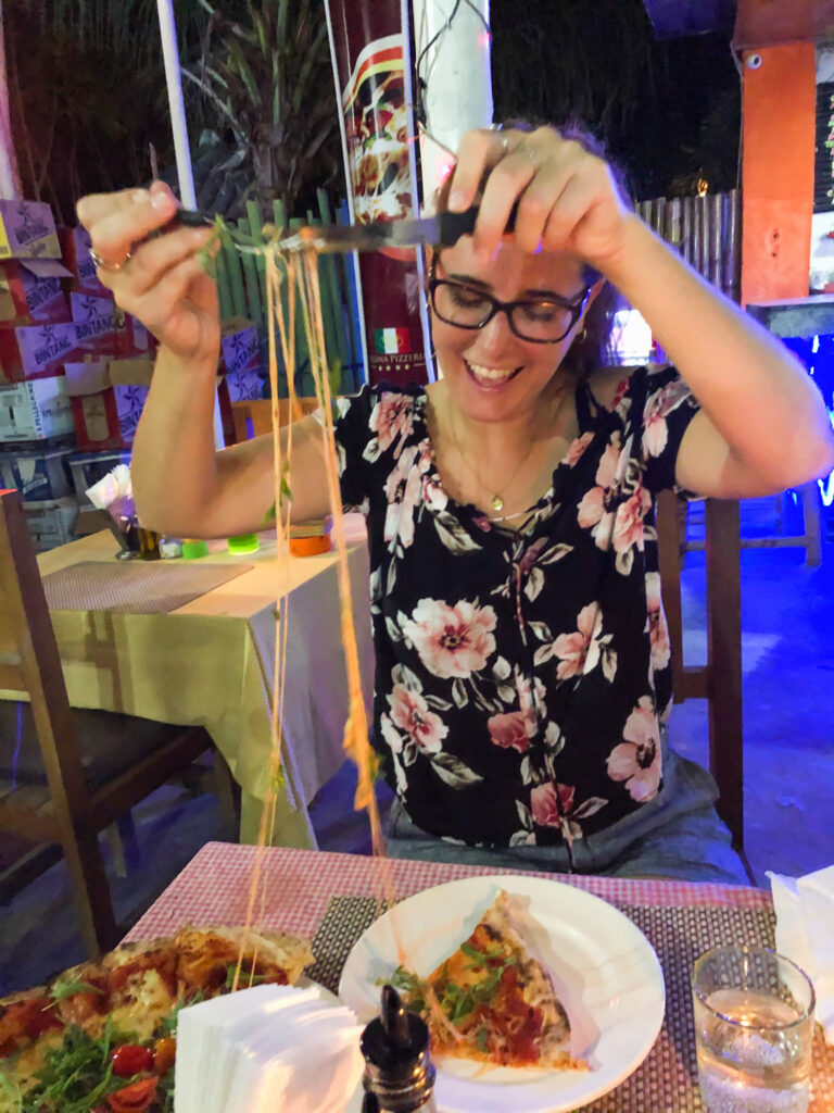 woman with pizza with lots of cheese string