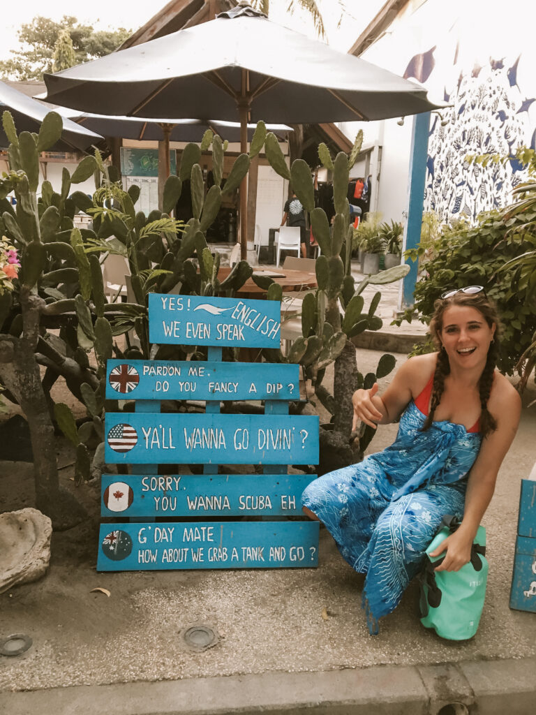 woman with a dive sign at manta dive gili t
