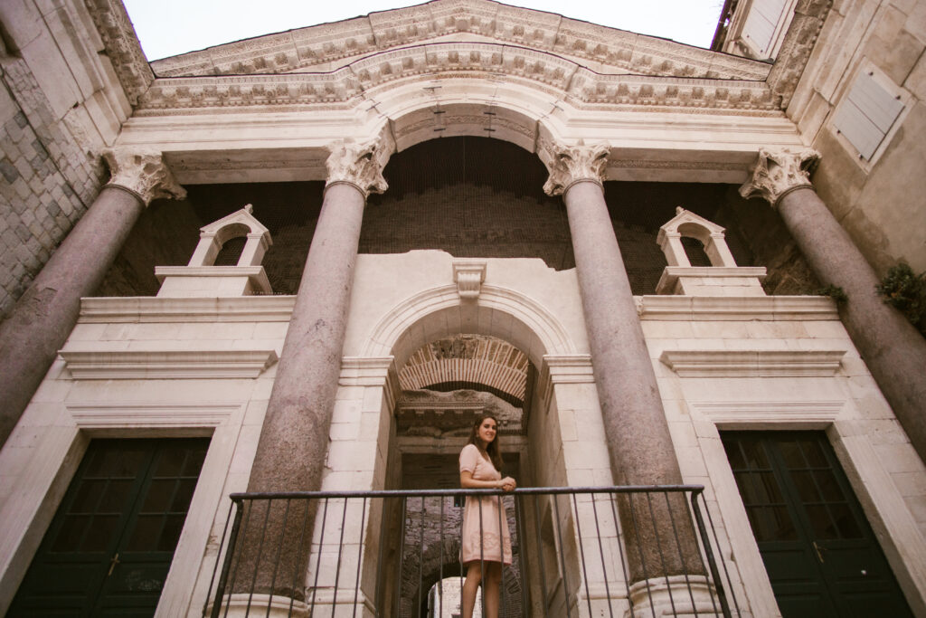 woman in pink dress in diocletians palace in split croatia