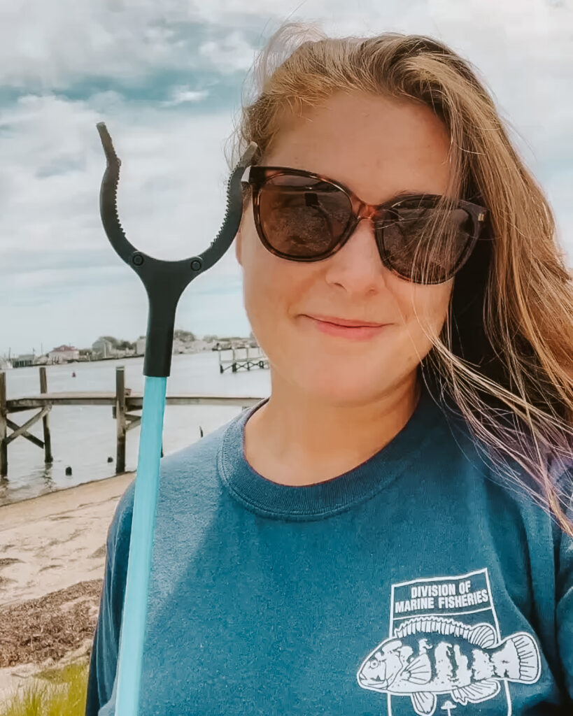 casey snook with trash picker at a beach clean