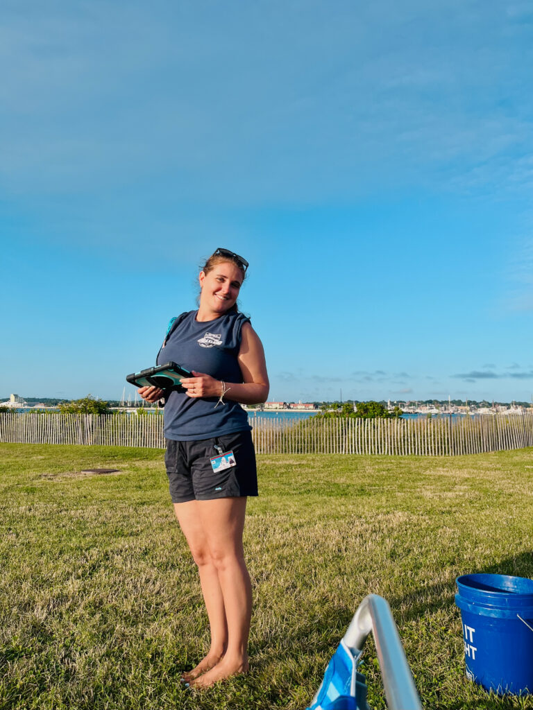 field scientist on grass with tablet