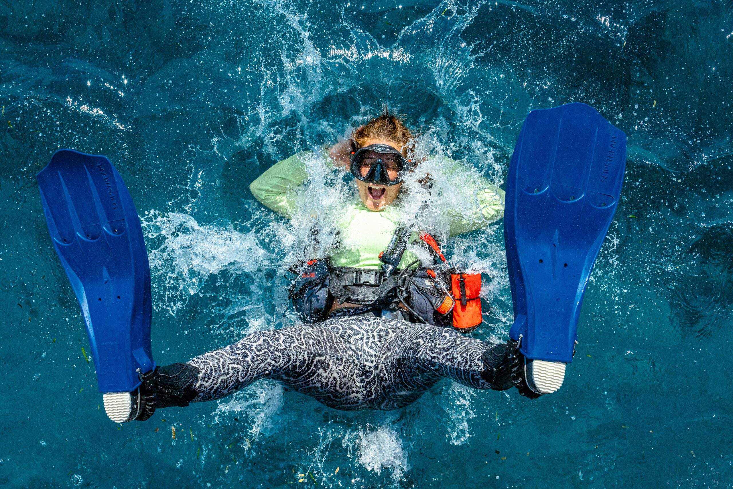 diver in brain coral pants doing a backroll entry splash
