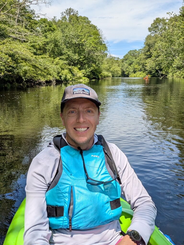 chris dodge in a canoe in narragansett bay